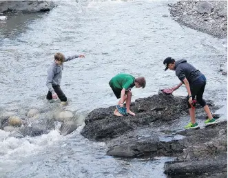  ??  ?? The intrepid adventurer­s tackle the perilous crossing of Bluerock Creek.