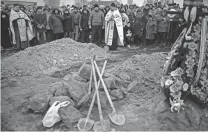  ?? EMILIO MORENATTI/AP ?? Friends and relatives mourn at the funeral Monday of Oleksandr Maksymenko, in his home village of Kniazhychi, east of Kyiv. Oleksandr, a civilian who was a volunteer in the armed forces of Ukraine, was killed in combat.