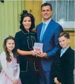  ??  ?? Natasha with her family on the day she received an OBE in 2017 for charity work