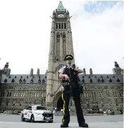  ?? SEAN KILPATRICK / THE CANADIAN PRESS ?? An RCMP officer stands watch on Parliament Hill after an incident during the Changing the Guard parade.