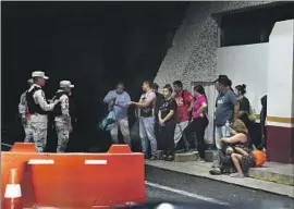  ?? Marco Ugarte Associated Press ?? MEXICO’S National Guard stops Venezuelan migrants at a checkpoint in Chiapas state last month. Border enforcemen­t efforts have left migrants on edge.