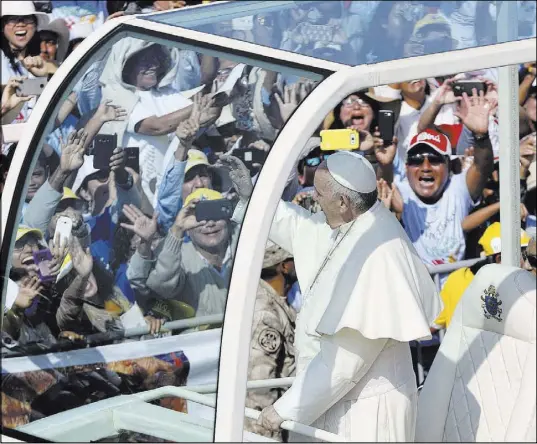  ?? Martin Mejia The Associated Press ?? Pope Francis waves from his popemobile as he arrives Saturday to celebrate Mass on Huanchaco Beach, near Trujillo, Peru.