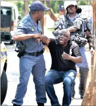  ?? PICTURE: THOBILE MATHONSI ?? Police arrest a Congolese man outside the DRC embassy in Arcadia, Pretoria, yesterday. The protest was part of worldwide action by DRC nationals at embassies calling on President Joseph Kabila to step down.