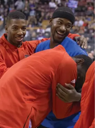  ?? RICK MADONIK/TORONTO STAR ?? Delon Wright looks on while Pascal Siakam hugs former Raptor Terrence Ross before his first game back in town with the Magic: “It was all a learning experience for me,” Ross said of the pre-deadline trade.