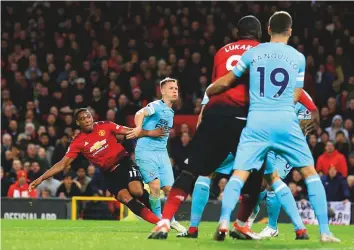  ?? AP ?? Manchester United’s Anthony Martial (left) scores the second goal during their Premier League match against Newcastle United. Manchester United won 3-2.