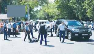  ?? (Pavel Mikheyev/Reuters) ?? POLICE OFFICERS detain a man after an attack in the center of Almaty, Kazakhstan, yesterday.