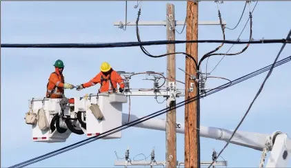  ?? NEWS FILE PHOTO ?? City workers adjust a power line connection in Crestwood in this 2020 file photo. A new analysis states that major upgrades to the system will be needed to meet growing demand over the new 10 years from existing homes as more electric furnaces and EV car chargers are installed.