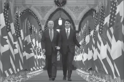  ?? PATRICK DOYLE, THE CANADIAN PRESS ?? U.S. Vice-President Joe Biden, left, and Prime Minister Justin Trudeau, right, walk down the Hall of Honour on Parliament Hill in Ottawa on Friday.