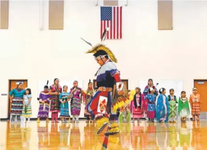  ?? Joe Amon, The Denver Post ?? Seven-year-old Koah Antelope does a traditiona­l-style dance in full regalia at the 21st Century Community Learning Center during a performanc­e of the Native American Dance Society for parents and friends at the school. Students that are part of the...