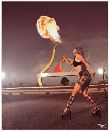  ?? COURTESY OF GARRETT GRANT ?? Mercy also performs firebreath­ing. Here she is photograph­ed in front of Isleta Amphitheat­er in Albuquerqu­e.