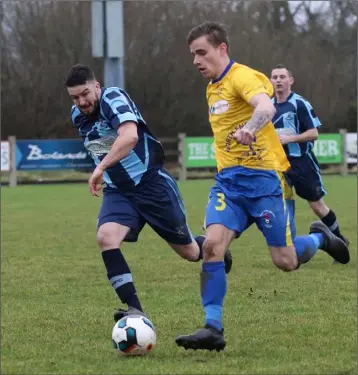  ??  ?? Dale Flynn of North End United bursts forward with Keith Dunne of St. Mochta’s in pursuit.