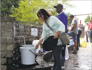  ?? ANWA ESSOP — ASSOCIATED PRESS ?? People collect water from a natural spring in Cape Town, South Africa, on Monday. The city’s supply runs out April 21.