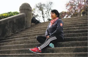  ?? Nina Riggio / Special to The Chronicle ?? Lizzie Siegle prepares for a run on the stairs at Lafayette Park in San Francisco. While running is an outdoor outlet for her, she says seeing more people out and about can cause her stress.