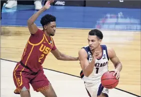  ?? Darron Cummings / Associated Press ?? Gonzaga guard Jalen Suggs, right, drives around Southern California guard Tahj Eaddy. Suggs had 18 points and 10 rebounds.