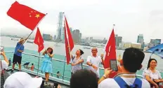  ?? Reuters ?? People wave Chinese and Hong Kong flags during a pro-China “Safeguard Hong Kong” rally at Tamar Park in Hong Kong.