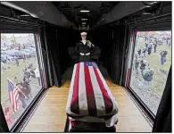  ?? AP/DAVID J. PHILLIP ?? An honor guard member watches over the casket of former President George H.W. Bush as the funeral train passes through Magnolia, Texas, on Thursday.