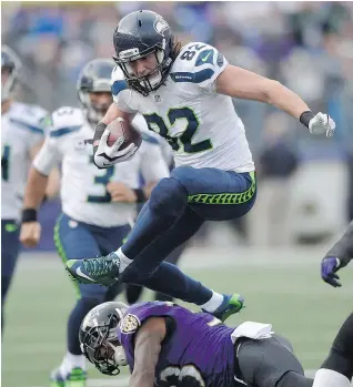  ?? — THE ASSOCIATED PRESS FILES ?? Seattle Seahawks tight end Luke Willson jumps over Baltimore Ravens strong safety Will Hill. Willson was recently in town for an event at the Hugo Boss store.