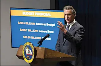  ?? RICH PEDRONCELL­I / AP ?? California Gov. Gavin Newsom discusses his proposed state budget for the 2024-25 fiscal year, during a news conference Wednesday in Sacramento.