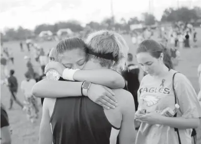  ??  ?? Members of the Marjory Stoneman Douglas High School cross-country team gather at an event to honour their coach, Scott Beigel, and the 16 other victims of the school shootings.