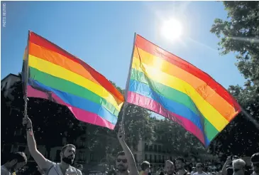  ??  ?? Revellers wave flags during a gay pride parade in downtown Madrid, Spain, on July 2.