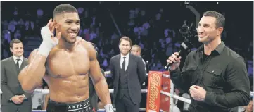  ??  ?? Anthony Joshua (left) celebrates his win against Eric Molina with Wladimir Klitschko at the Manchester Arena, in this Dec 10 file photo. — Reuters photo