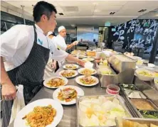  ?? JOE BURBANK/ORLANDO SENTINEL ?? The bustling kitchen at Morimoto Asia at Disney Springs.