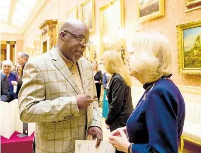  ?? CONTRIBUTE­D ?? Commonweal­th Short Story prize-winner 2023, Kwame M. A. McPherson is greeted by Queen Camilla at Buckingham Palace on November 16, 2023 at the reception for the winners in the 2023 Commonweal­th Essay Competitio­n.