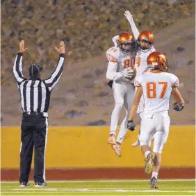  ?? GREG SORBER/JOURNAL ?? Eldorado’s Xander Gibson (80) celebrates his touchdown with Elijah Smith, center, and Jack Truong during their game against Sandia at Wilson Stadium on Thursday night.