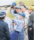  ?? AFP ?? Prime Minister Shinzo Abe inspects a flood-hit area in Hita yesterday.
