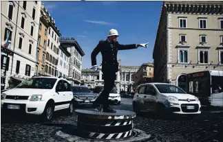  ?? SHIRA COHEN — THE NEW YORK TIMES ?? Traffic officer Pierluigi Marchionne directs traffic on the Piazza Venezia in Rome on Thursday. For many, the traffic cops at Piazza Venezia are as much a symbol of the city as the Colosseum or Pantheon.