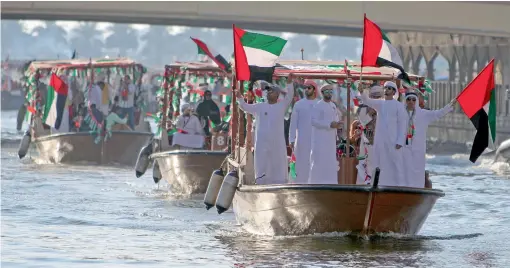  ?? —File photo ?? People take a ride on boats at Qanat Al Qasba, Sharjah, as part of last year’s national day celebratio­ns. Festivitie­s will continue until December 6.