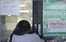  ?? NAM Y. HUH — THE ASSOCIATED PRESS ?? A shopper enters a retail store as a hiring sign shows in Buffalo Grove, Ill. America’s employers added 850,000 jobs in June, well above the average of the previous three months and a sign that companies may be having an easier time finding enough workers to fill open jobs.