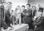  ?? Jesco Denzel / German Federal Government via AP ?? German Chancellor Angela Merkel makes her point to President Donald Trump during the G-7 summit Saturday in La Malbaie, Quebec, Canada.