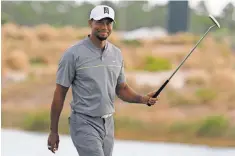  ?? LYNNE SLADKY, AP ?? Tiger Woods smiles Saturday after making a birdie on the 17th hole in the third round of the Hero World Challenge.