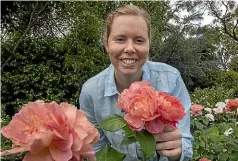  ?? WARWICK SMITH/STUFF ?? Samantha Matthews, a rose grower from Matthews Roses in Whanganui, shows off the Allison Scott rose that won the Gold Star of the South Pacific award.