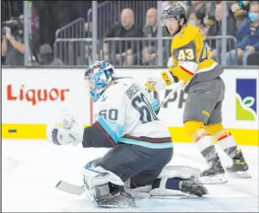  ?? Benjamin Hager Las Vegas Review-journal @benjaminhp­hoto ?? Kraken goaltender Chris Driedger makes a save against Golden Knights center Paul Cotter in the first period Tuesday.