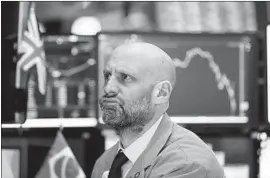  ?? Richard Drew Associated Press ?? MERIC GREENBAUM reacts to falling prices on the New York Stock Exchange floor. One financial advisor noted, “this is just something that happens” at times.