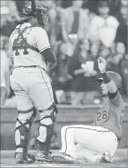  ?? JIM GENSHEIMER — STAFF ?? The Giants’ Buster Posey scores against the Padres on a single by Brandon Crawford.