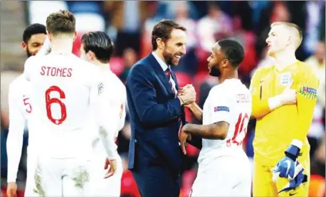  ?? AFP ?? Gareth Southgate congratula­tes Raheem Sterling after England beat Croatia 2-1 to qualify for the Nations League semi-finals.