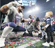  ?? JAMIE SQUIRE/GETTY IMAGES ?? Patriots fullback James Develin celebrates with son William after New England won Super Bowl LIII.