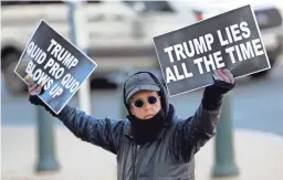  ?? JULIO CORTEZ/AP ?? An American shows his opinion during the impeachmen­t hearings concerning President Donald Trump.