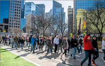  ?? Alexandra Wimley/Post-Gazette ?? Demonstrat­ors march down Liberty Avenue toward Point State Park in Downtown during a protest against mask mandates and other COVID-19 restrictio­ns Saturday.