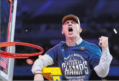  ?? BRYNN ANDERSON/AP PHOTO ?? UConn head coach Dan Hurley celebrates cutting the net after the Huskies beat Purdue in the NCAA tournament championsh­ip game on Monday night in Glendale, Ariz.