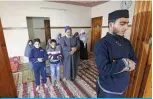  ?? —AFP ?? GAZA CITY: Palestinia­n Saleh Shtaiwi, who usually calls for prayers and leads them at a mosque, leads the Friday prayer for his family at home.