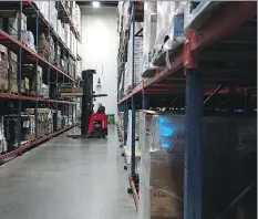  ?? AARON P. BERNSTEIN/BLOOMBERG ?? A worker drives a forklift in a stockroom at the Tulkoff Food Products factory in Baltimore, Md. Owner Philip Tulkoff practises zero-tolerance when it comes to employees using drugs.