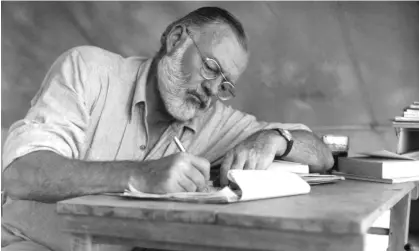  ?? Photograph: Earl Theisen Collection/Getty Images ?? Hemingway working during a big game hunt in Kenya in September 1952.