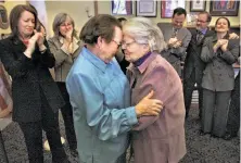 ?? Liz Mangelsdor­f / The Chronicle 2004 ?? Phyllis Lyon, left, and Del Martin, who had been together for more than 50 years, embrace after their marriage at City Hall.