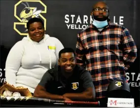  ?? ?? Starkville High School baseball player Caden Tate, seated, shares in the moment of signing with East Mississipp­i Community College with his parents on Thursday. (Photo by Danny P. Smith, SDN)