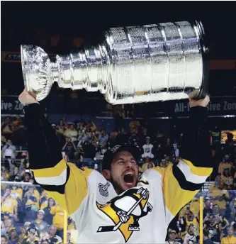  ?? GETTY IMAGES FILE PHOTO ?? Sidney Crosby of the Pittsburgh Penguins celebrates with the Stanley Cup after they defeated the Predators, 2-0, to win the NHL championsh­ip at the Bridgeston­e Arena in Nashville last June 11.