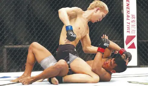  ??  ?? Ulka Sasaki of Japan pummels on Jenel Lausa during the UFC Fight Night at the Singapore Indoor Stadium.